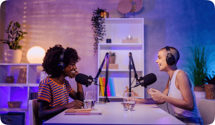 Two hosts recording together in a home studio